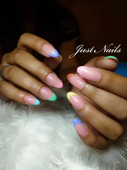 A fun and colorful twist on the French manicure, with each nail tip painted a different pastel color.