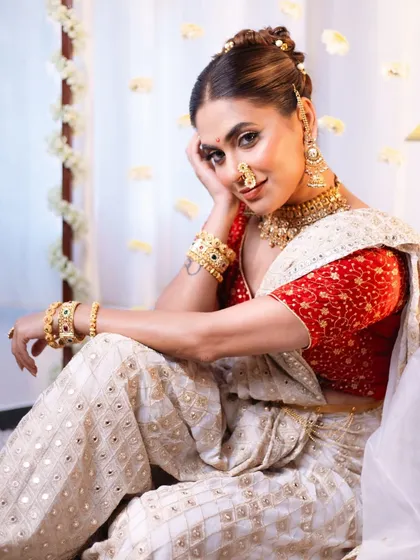 A full-length shot from the "Apsara" themed shoot, showing the complete look with the elegant saree drape and regal pose.