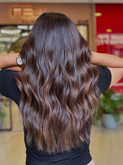 This image showcases the beautiful, flowing waves and the intricate details of a brunette balayage. Each strand is purposefully colored to contribute to the overall look.