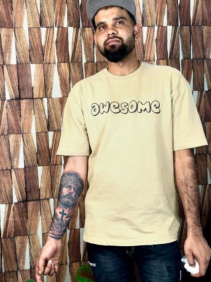 A client proudly showing his new Jesus portrait tattoo on his forearm. This powerful piece captures the suffering and divinity of Christ, created with deep, contrasting shades.