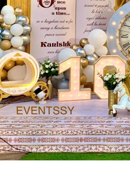 Details from the royal party, including a storybook prop telling the prince's tale, marquee number lighting for the age "10," and a miniature royal carriage.