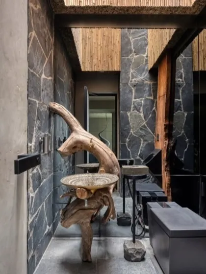 I believe in the honesty of materials. This washbasin, sculpted from a single piece of reclaimed wood, is not just a functional object but a piece of art that tells a story of nature's raw beauty.