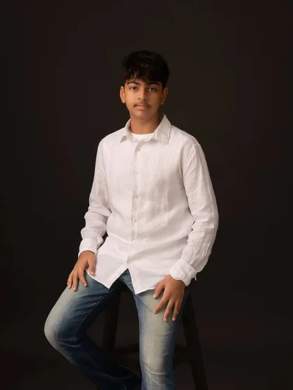 A relaxed, seated portrait of my son. The simple setup allows his personality to shine through.