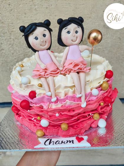 I didn't want to part with this adorable cake. It features two custom-made girl figurines sitting atop a bed of pink ombre buttercream ruffles, celebrating a special bond between sisters or best friends.
