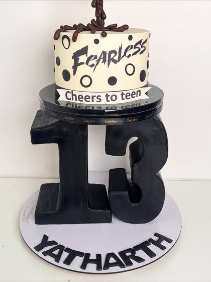 A view of the gravity-defying Coke cake from the side, showing the sculpted number 13 that forms the base.