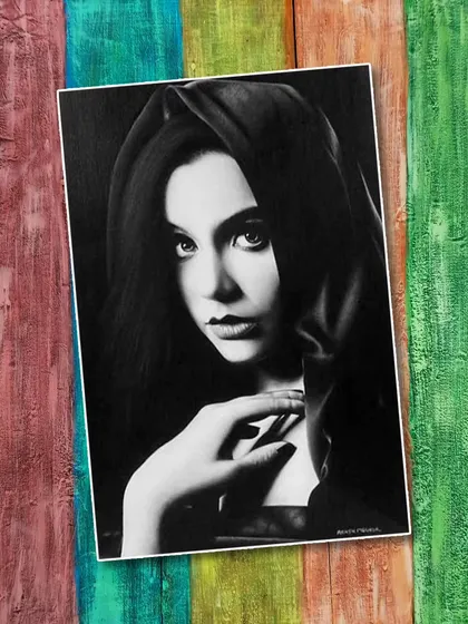 A captivating pencil portrait by artist Akash Maurya. The use of high contrast and dramatic lighting gives the subject an enigmatic, almost classical quality, drawing the viewer into her gaze.