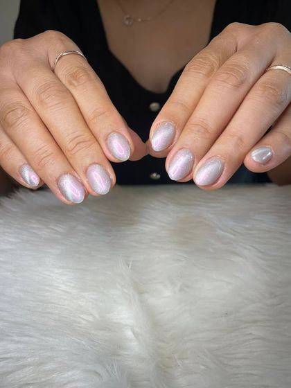 A soft, shimmery cat eye effect on short, natural nails.