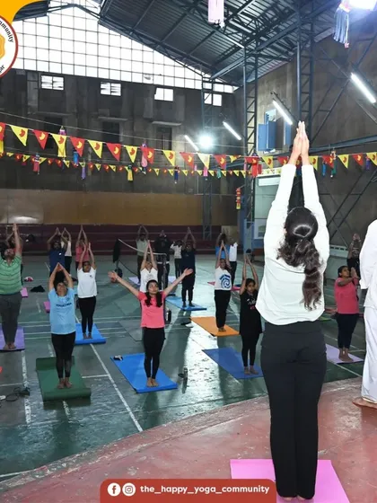 Students in Urdhva Hastasana (Raised Hands Pose) during our group practice. The collective energy of the room is palpable.