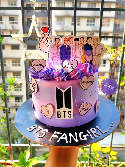 A cake for the ultimate BTS fangirl. This purple galaxy-themed cake is decorated with the BTS logo and hearts featuring the members' names, a perfect tribute for any ARMY member.