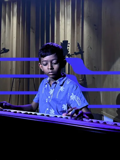 The spotlight is on this young keyboardist as he performs during our May Intramural Series. The professional lighting and stage setup give our students a true concert experience.