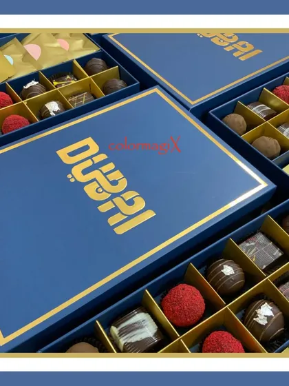 A close-up of our "Dubai" branded corporate chocolate box. The rich blue and gold combination exudes luxury, while the chocolates inside are a delightful treat.