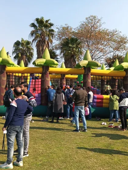 A wide shot of the jungle bouncy castle at a corporate family day, showing how it can entertain a large group of children and adults at once.