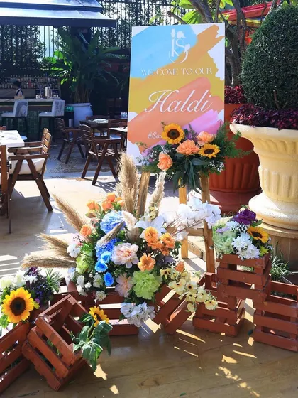 A rustic and floral welcome setup for the Haldi, using wooden crates and sunflowers for a charming, sunny vibe.