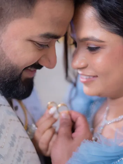 An intimate close-up of the couple. You can see the details of the bride's soft, shimmery eye makeup and the overall radiant finish.
