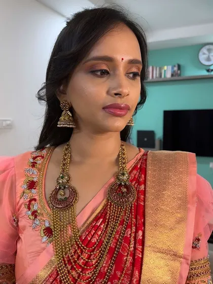 A simple yet elegant party look. The makeup features a soft brown eyeshadow and a glossy pink lip, perfect for a guest attending a traditional wedding event.