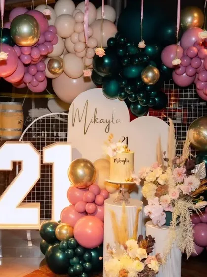 A closer look at the personalized backdrop for the 21st birthday, with the name 'Mikayla' in elegant script.