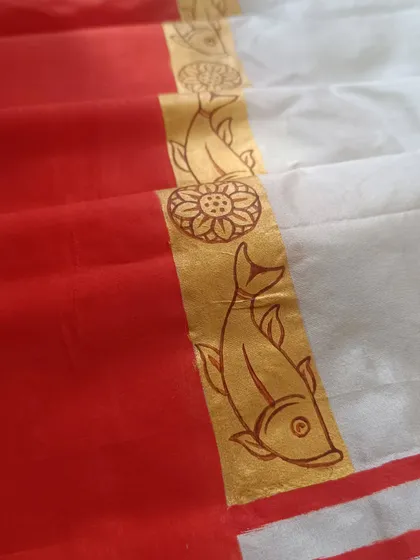 My art extends to wearable ritual textiles, like this hand-painted 'Sada laal' saree for Durga Puja. The motifs of fish and lotus are not merely decorative; they are researched symbols of auspiciousness and divinity, turning a traditional garment into a sacred offering.