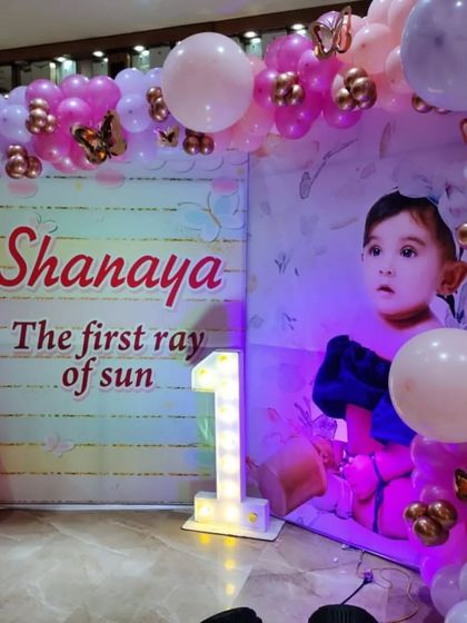 A beautiful photo backdrop for a butterfly-themed party, with a large picture of the birthday girl.