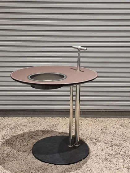 A functional side table with a built-in ice bucket, perfect for entertaining guests.