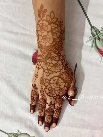 The beautiful reddish-brown stain of a floral Arabic design after the paste has been removed.