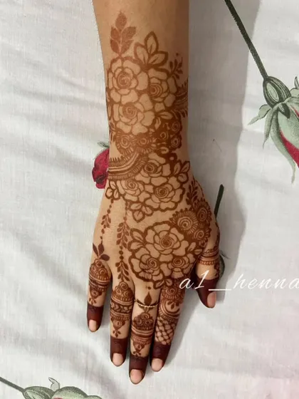 Another angle of the floral henna design, highlighting the graceful flow of the pattern from the wrist down to the fingers.