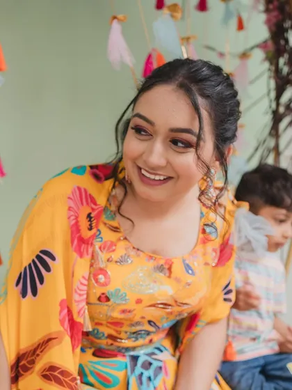 A candid moment of the bride enjoying her Mehendi ceremony. The makeup is designed to be long-lasting and photo-ready, even during the most candid moments.
