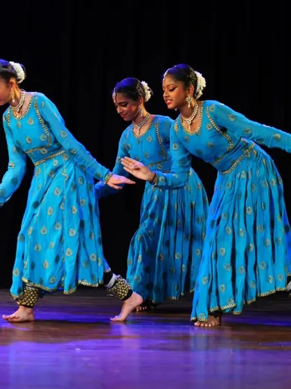 Three of my senior students executing a synchronized movement, highlighting their precise footwork and elegant posture during the Chota Canvas Dance Festival.