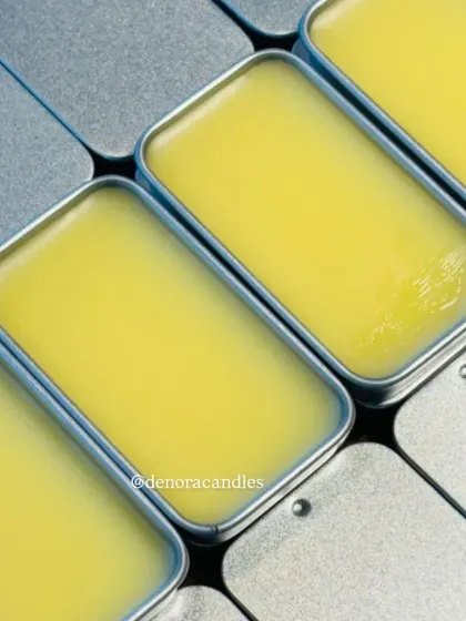 A close-up, patterned shot of multiple solid perfumes, showcasing their consistent quality and smooth finish.