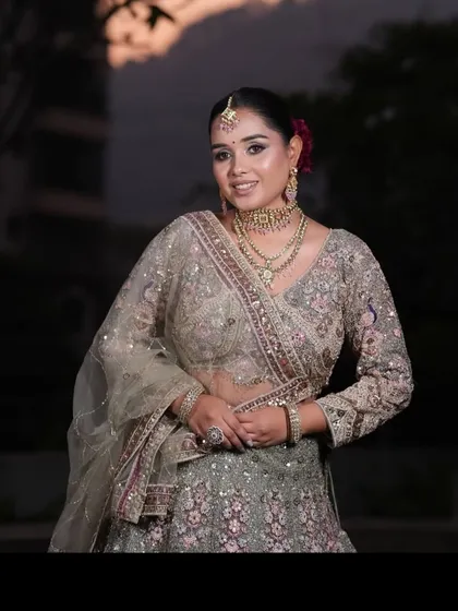 A beautiful evening shot of a client in our grey and pink embroidered lehenga. The outfit sparkles under the lights, making it perfect for a reception.