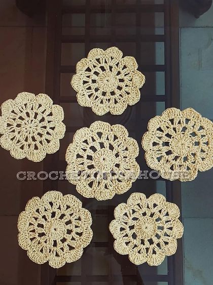 These beautiful cream-colored crochet doily coasters feature an open, floral-inspired pattern that is both delicate and functional.