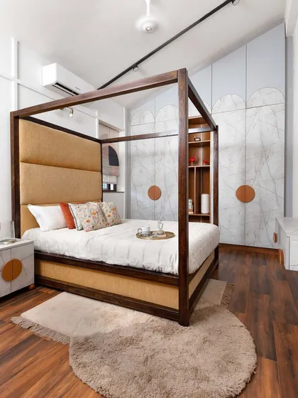 We designed this bedroom around a dramatic four-poster bed and a custom wardrobe with a subtle marble-effect finish. The design integrates a display nook directly into the wardrobe, blending storage with opportunities for personal expression and creating a cohesive, serene retreat.