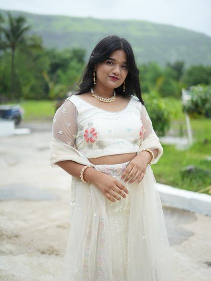 A close-up of the delicate floral embroidery on the white lehenga. It’s all in the details.