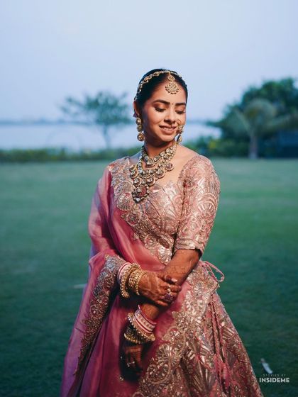 A candid moment of the bride, Tanisha, looking serene and happy. Her soft glam makeup look, featuring a subtle pink lip and defined brows, was designed to last all day and look perfect in professional wedding photography.
