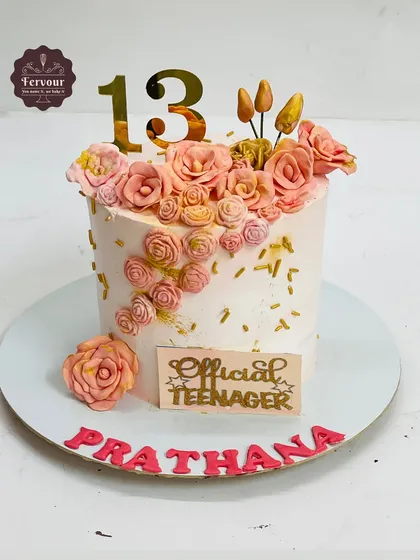 An elegant "Official Teenager" cake for a 13th birthday. This cake is decorated with a cascade of handmade fondant roses in beautiful peach tones.