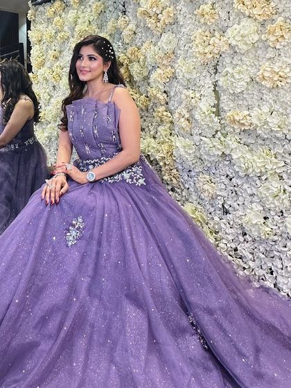 A closer look at the lavender evening gown. This image highlights the delicate silver embellishments on the bodice and the shimmering quality of the tulle skirt.