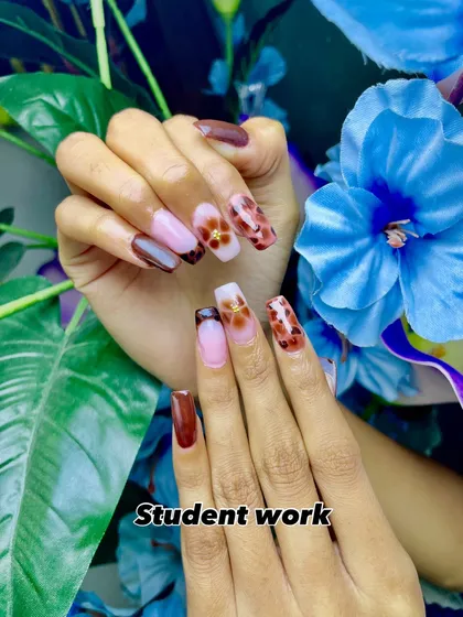A closer look at a student's creation. This design includes a mix of brown tones, a translucent base, and detailed floral and leopard print art.