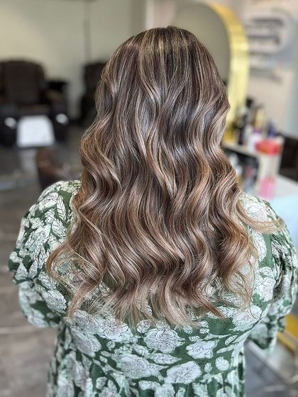 A full back view of the cool vanilla balayage, styled with loose waves to showcase the intricate color work.