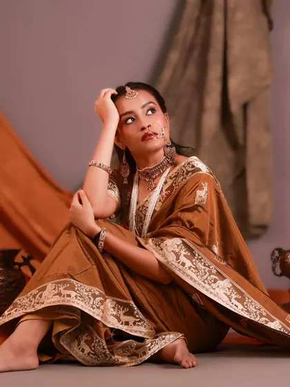 A dramatic and emotional pose on the floor. The composition and her upward gaze create a sense of longing and storytelling.