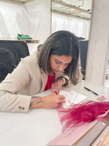 A shot of me at a live event, focused on my work. I've built a wardrobe of classic, neutral pieces that allow me to look professional while still feeling comfortable and like myself.