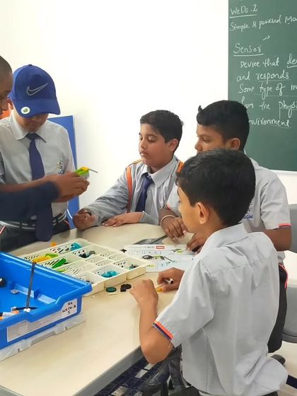 An instructor guides a team of students at The School for Global Minds. We provide personalized attention to ensure every child understands the concepts and contributes to the project.
