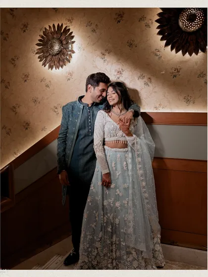 A cozy and romantic shot of the couple in a quiet corner. The groom's arm around the bride and their close proximity create a feeling of intimacy and comfort.