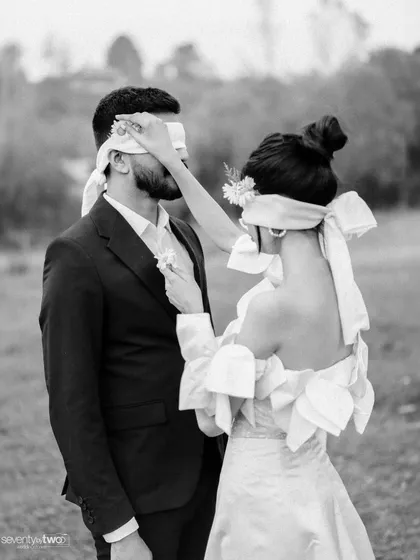 A tender, blindfolded moment. She reaches out to touch his face, a gesture of care and connection that transcends sight. This is love as a feeling, not just a sight.