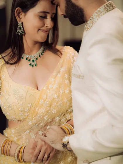 A close-up portrait focusing on the quiet intimacy between the couple. This shot highlights their elegant traditional attire and the gentle connection they share, perfect for an engagement album.