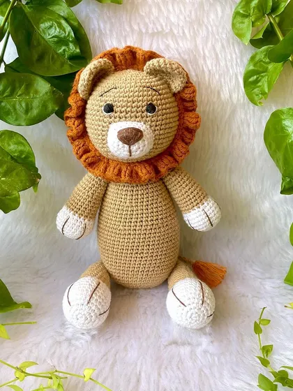 This large lion in a soft beige color is so huggable. His gentle expression and soft mane make him a comforting friend for children.