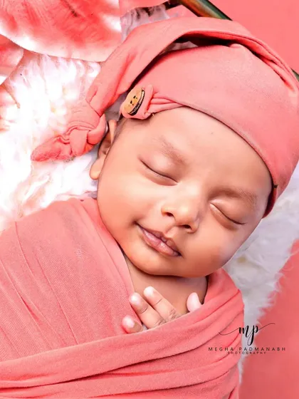 A beautiful, gentle smile from a sleeping baby.