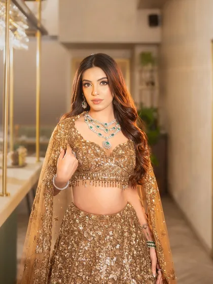 For the bride who wants to shine at her reception or cocktail party. I created these voluminous, soft glam waves to complement this stunning golden lehenga, ensuring she glittered with every step.