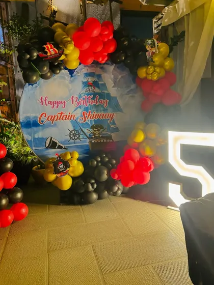 The pirate party setup with a light-up marquee number '5'.