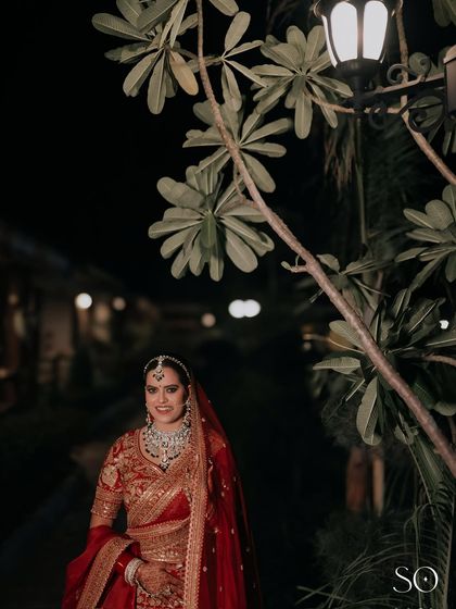 A candid moment of the bride, her radiant smile enhanced by the classic makeup look.