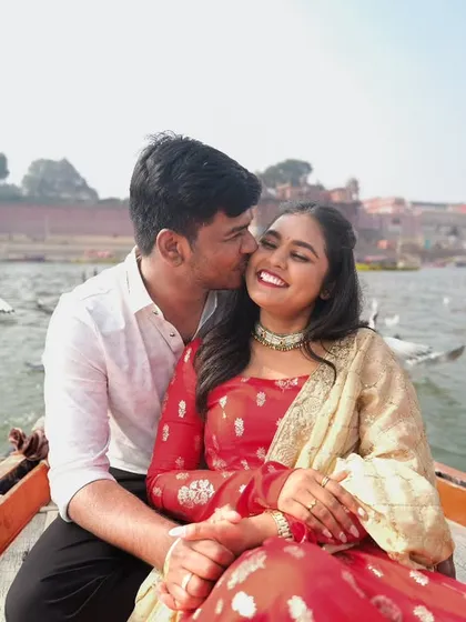 Love flows like the Ganga in the heart of Varanasi. A tender moment between a couple on a boat, surrounded by birds, capturing the romance of this ancient city.