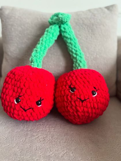 Another look at our adorable cherry plush toy, perfect for adding a touch of handmade charm to a sofa or bed.